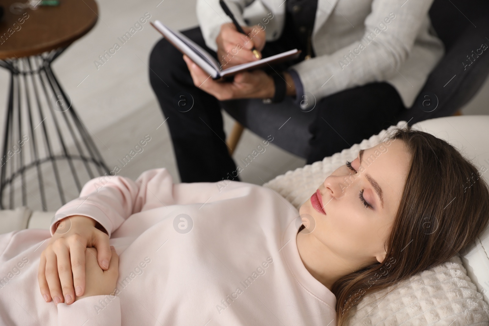 Photo of Psychotherapist and patient in office. Hypnotherapy session