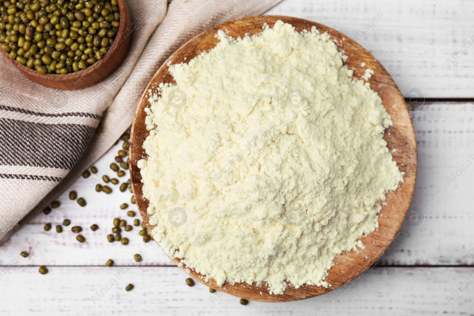 Photo of Plate with mung bean flour and seeds on white wooden table, flat lay