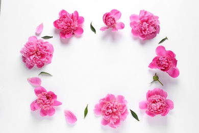 Photo of Frame made with fresh peonies on white background, top view. Space for text