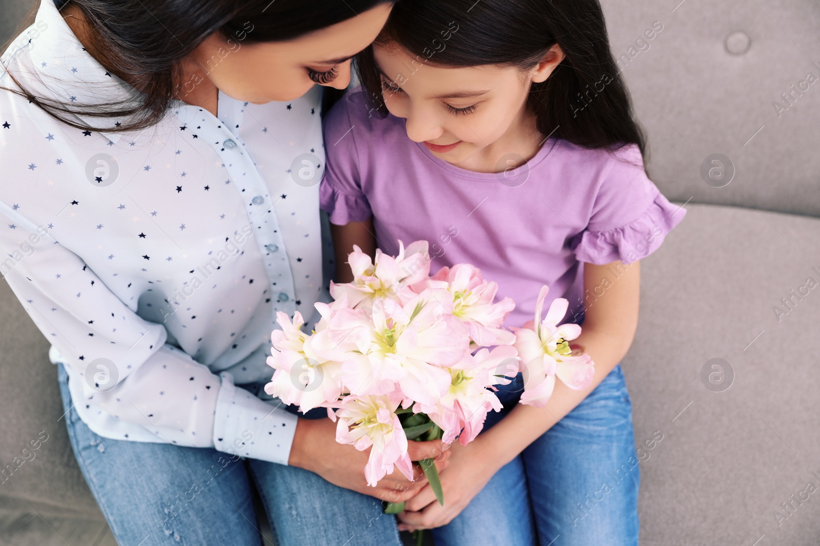 Photo of Little daughter congratulating her mom, above view. Happy Mother's Day