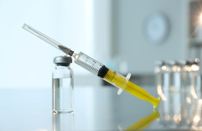 Photo of Syringe with vial of medicine on table