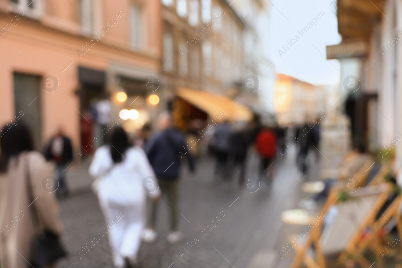 Photo of Blurred view of people walking on city street