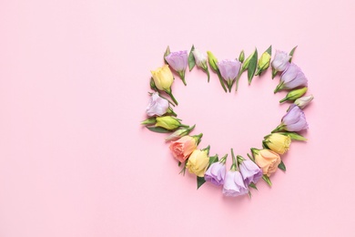 Photo of Flat lay composition with beautiful Eustoma flowers on pink background, space for text