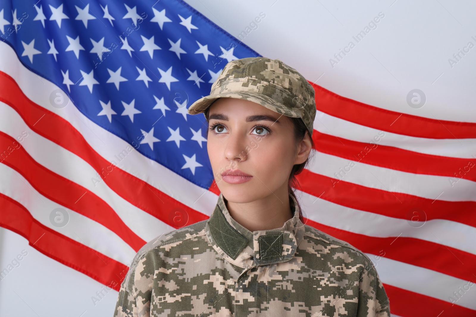 Photo of Female soldier in uniform and United states of America flag on white background