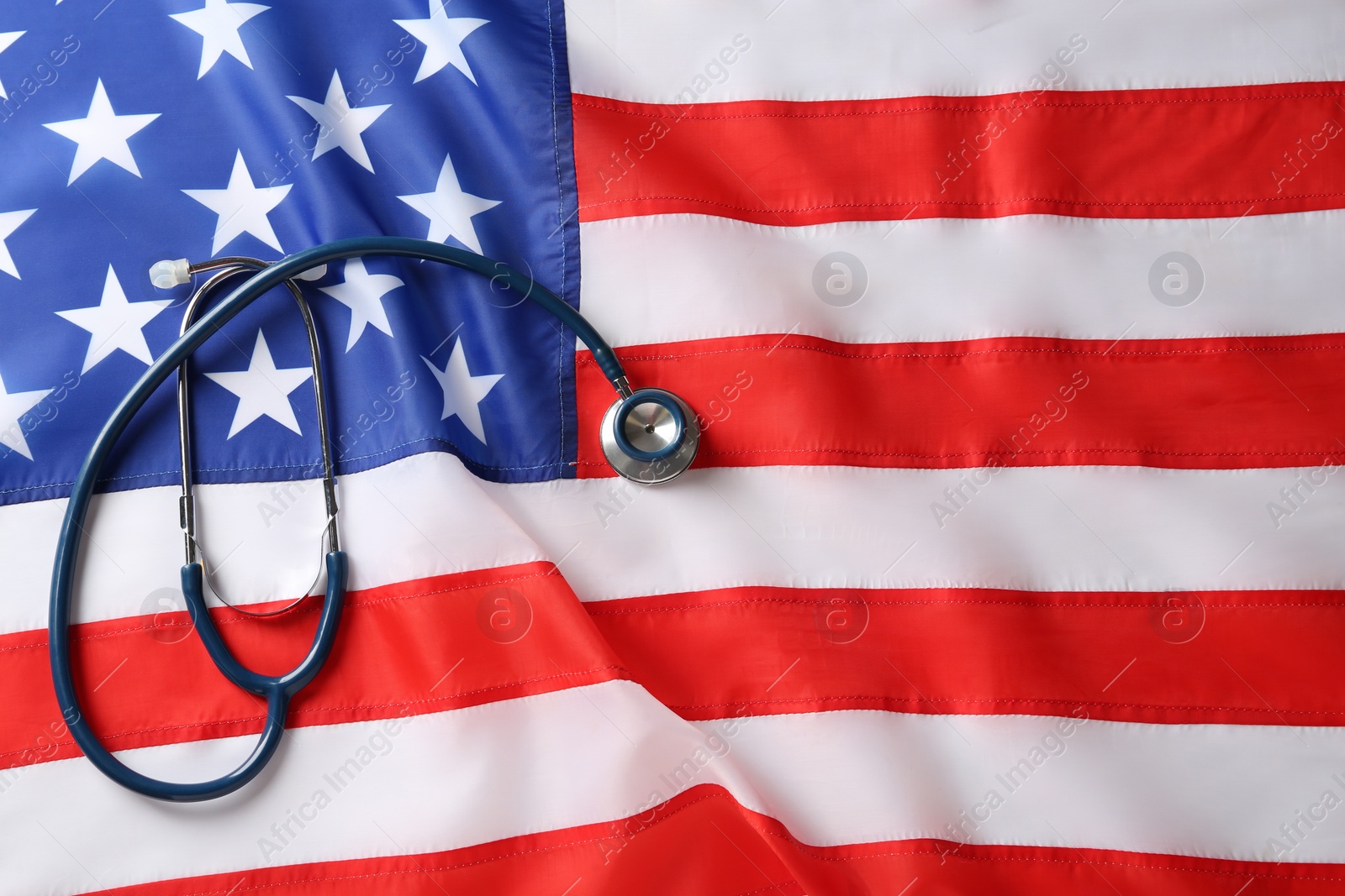 Photo of Stethoscope on American flag, top view. Space for text