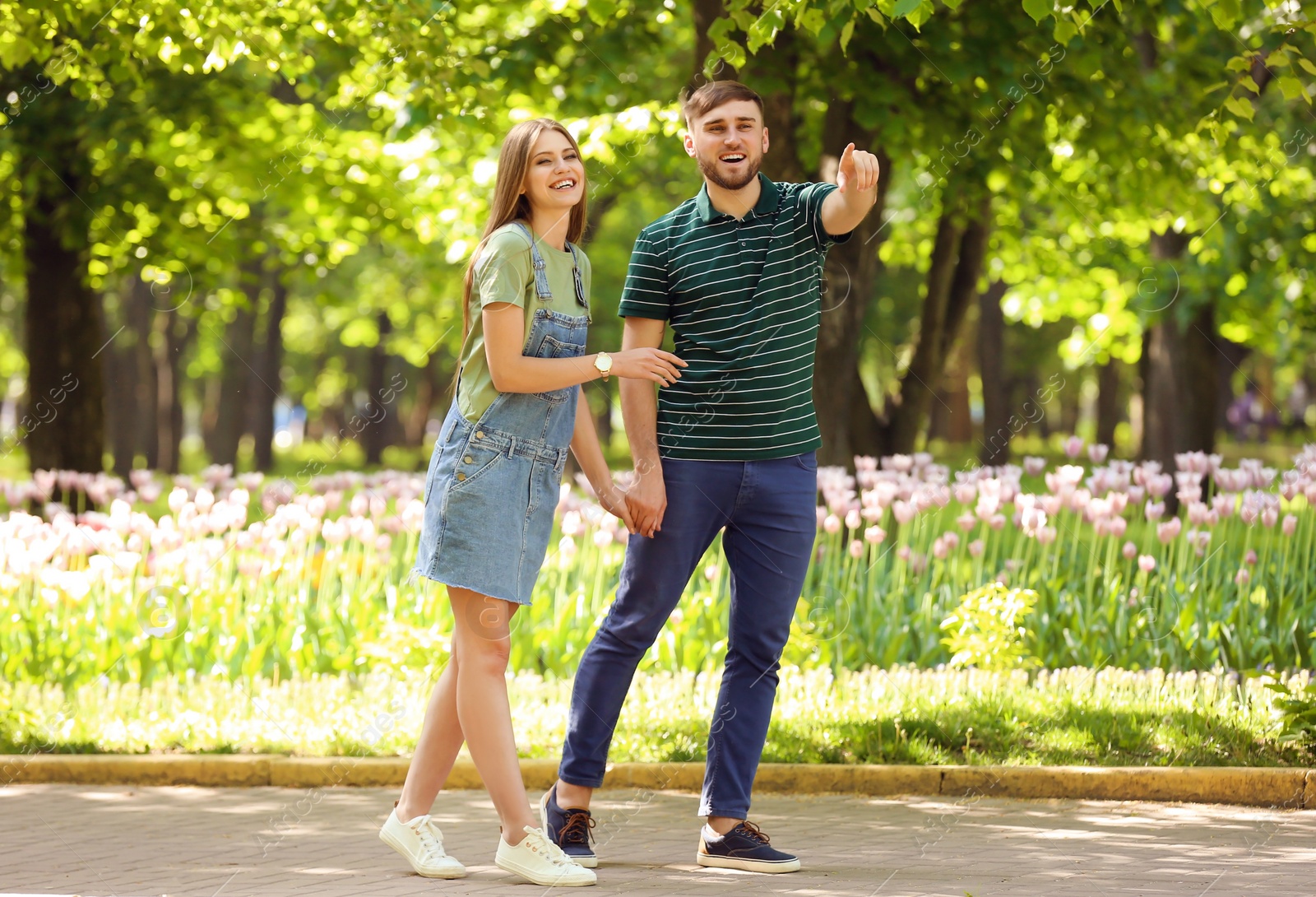 Photo of Happy young couple in green park on sunny spring day