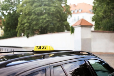 Photo of Car with yellow taxi roof sign outdoors