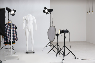 Ghost mannequin and rack with clothes in professional photo studio