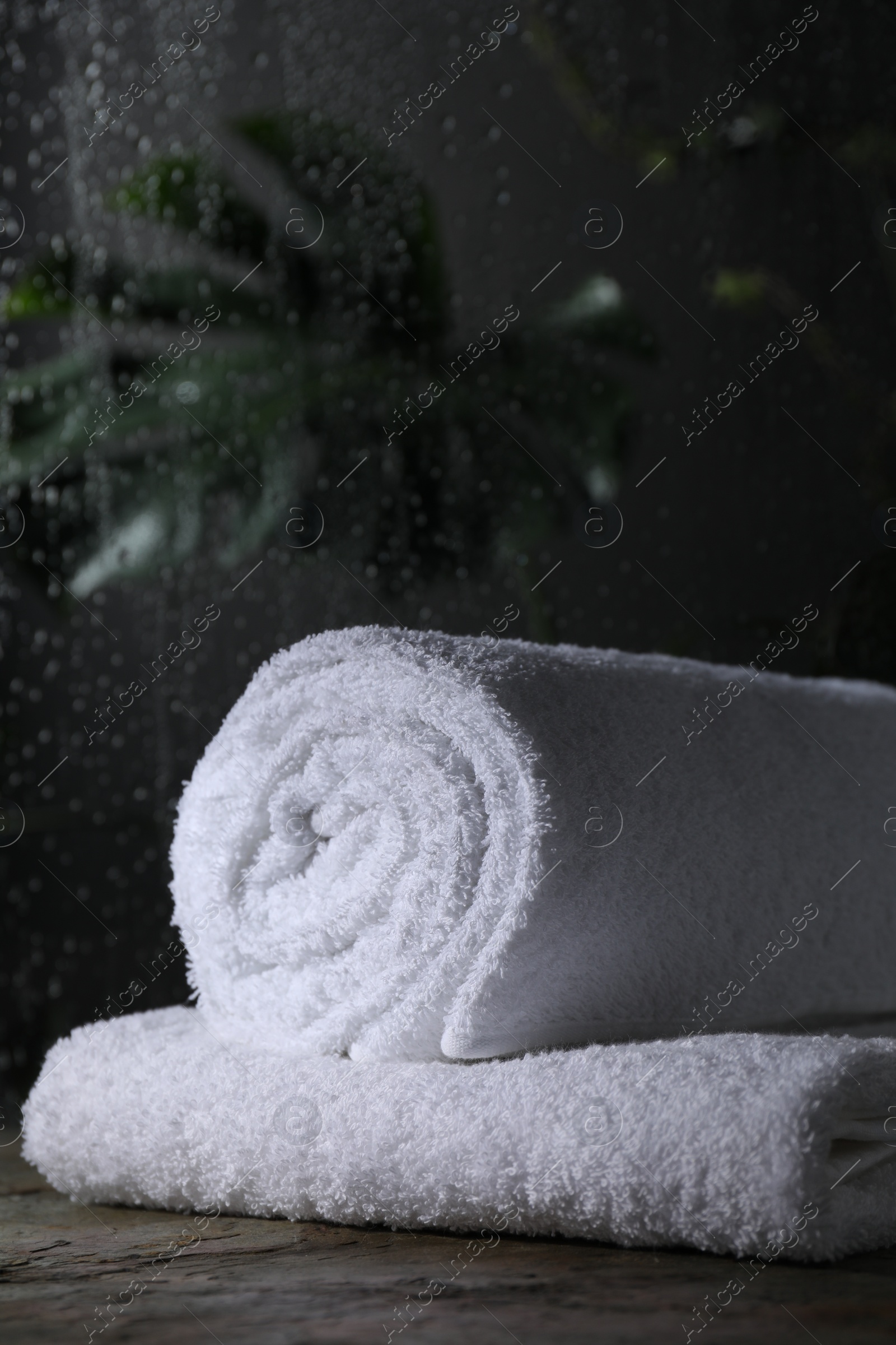 Photo of White terry towels on table in bathroom