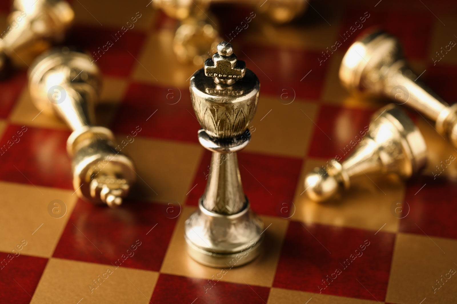 Photo of Wooden chessboard with game pieces, closeup view