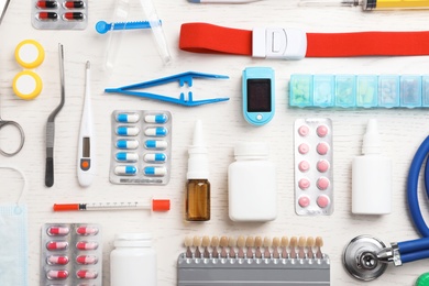 Flat lay composition with medical objects on white wooden background