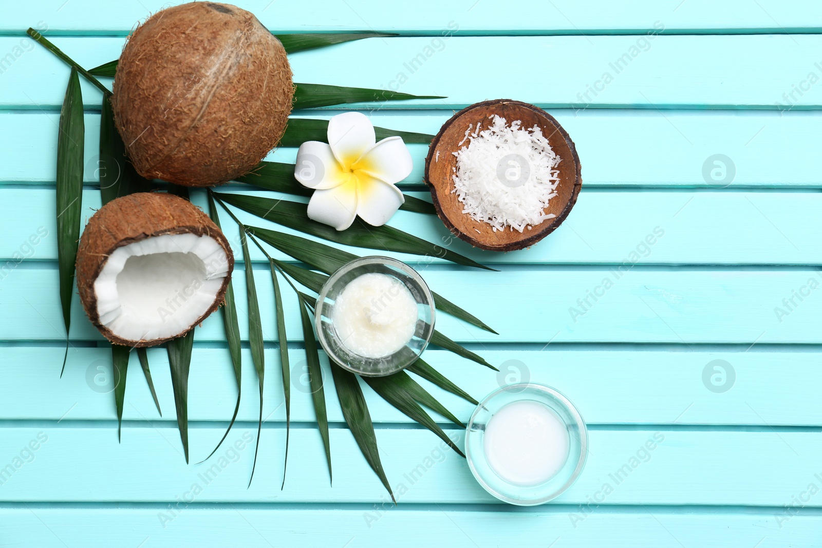 Photo of Beautiful composition with coconut oil and nuts on wooden background