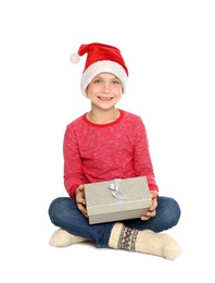 Cute little child in Santa hat with Christmas gift box on white background