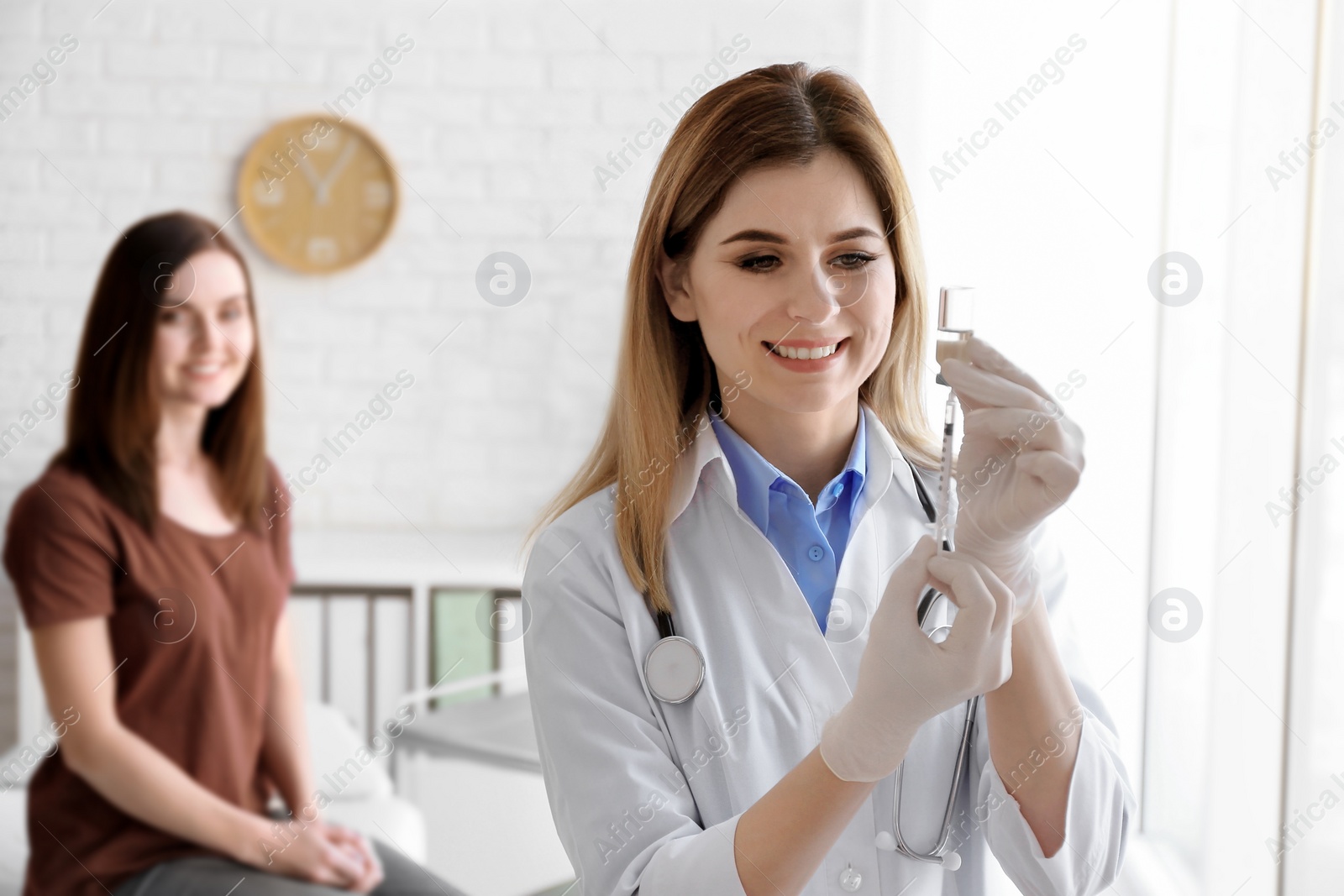 Photo of Doctor vaccinating female patient in clinic