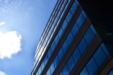 Photo of Modern building against blue sky, low angle view