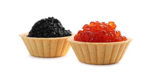 Photo of Delicious tartlets with red and black caviar on white background