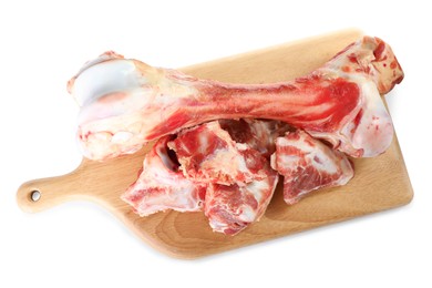 Photo of Wooden board with raw meaty bones on white background, top view