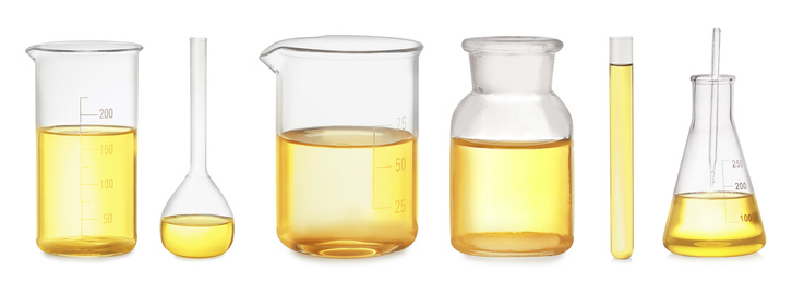Image of Set of laboratory glassware with yellow liquid on white background. Banner design