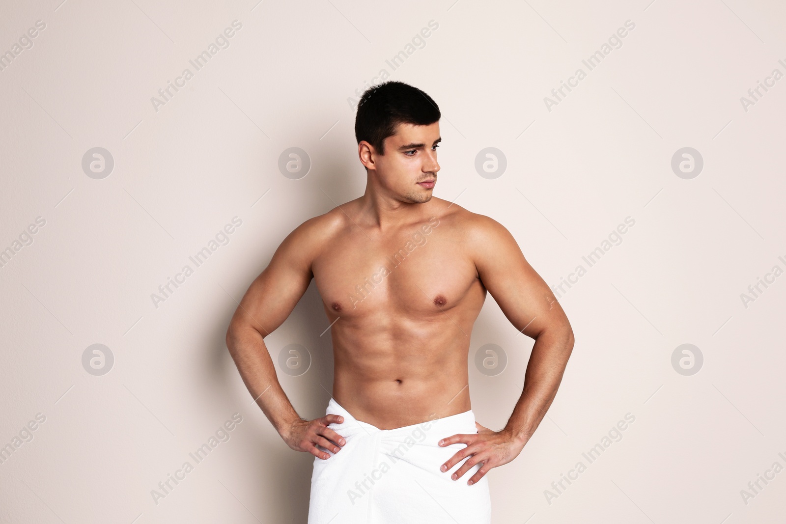 Photo of Man with sexy body on beige background