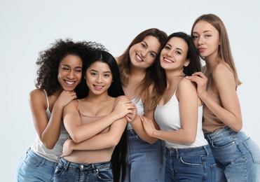 Photo of Group of women with different body types on light background