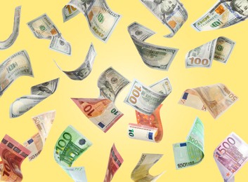 Image of Money exchange. Dollar and euro banknotes falling on light yellow background