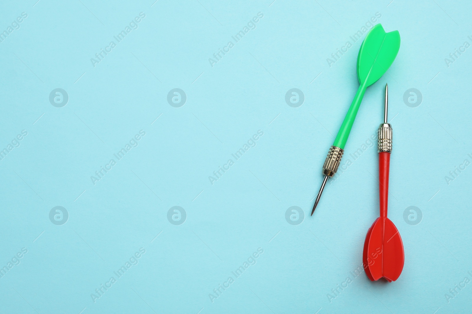 Photo of Plastic dart arrows on blue background, flat lay with space for text