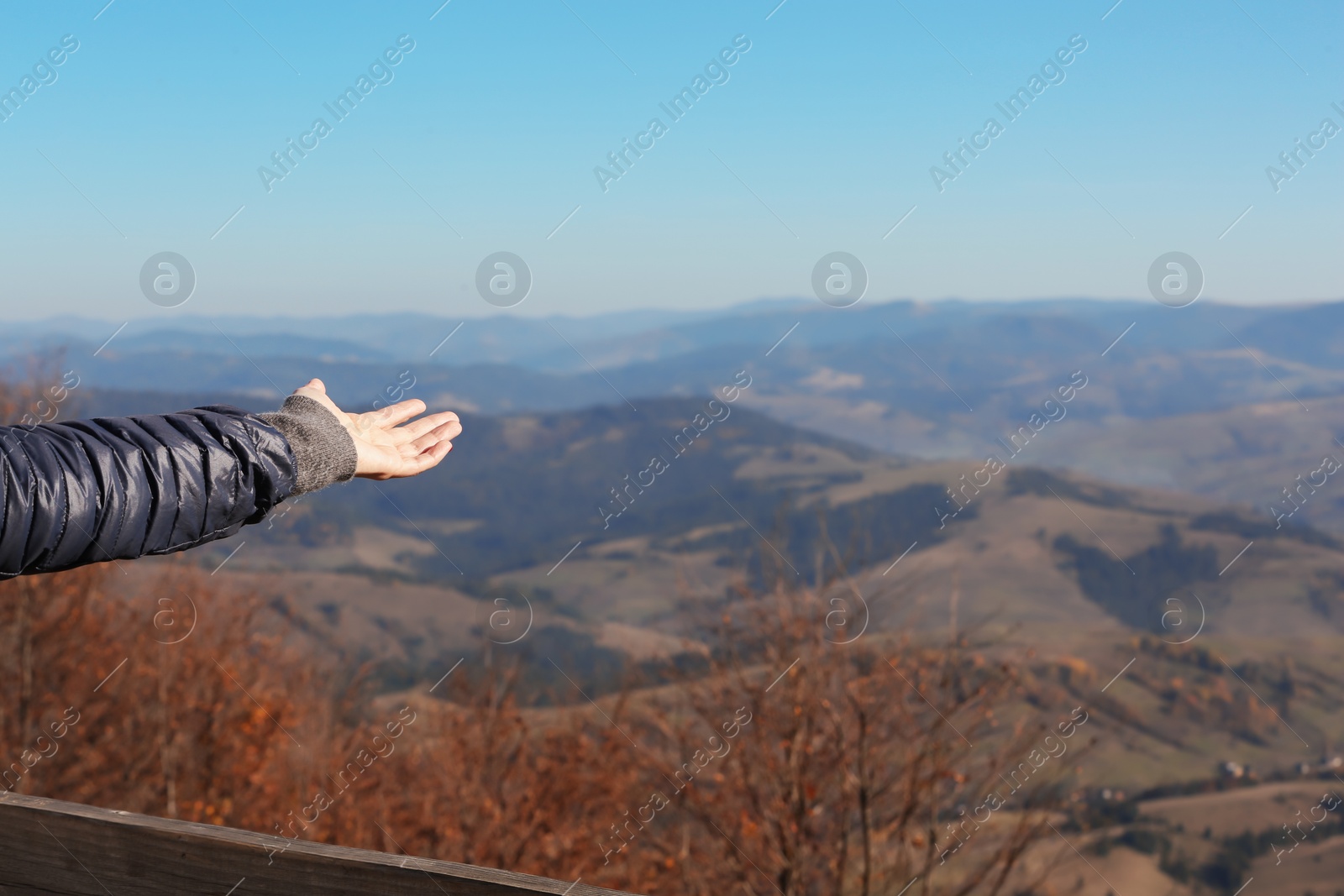 Photo of Woman showing beautiful mountain landscape on sunny day
