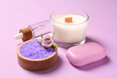 Photo of Sea salt, candle and soap bar on pink background