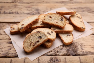 Photo of Sweet hard chuck crackers with raisins on wooden table