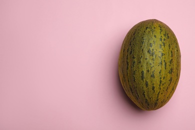 Photo of Whole ripe tasty melon on pink background, top view. Space for text