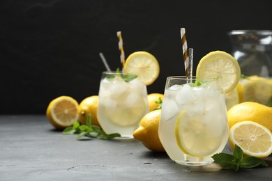 Photo of Natural lemonade with mint on grey table, space for text. Summer refreshing drink