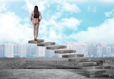 Image of Woman standing on top of stairs and looking at cityscape. Way to success