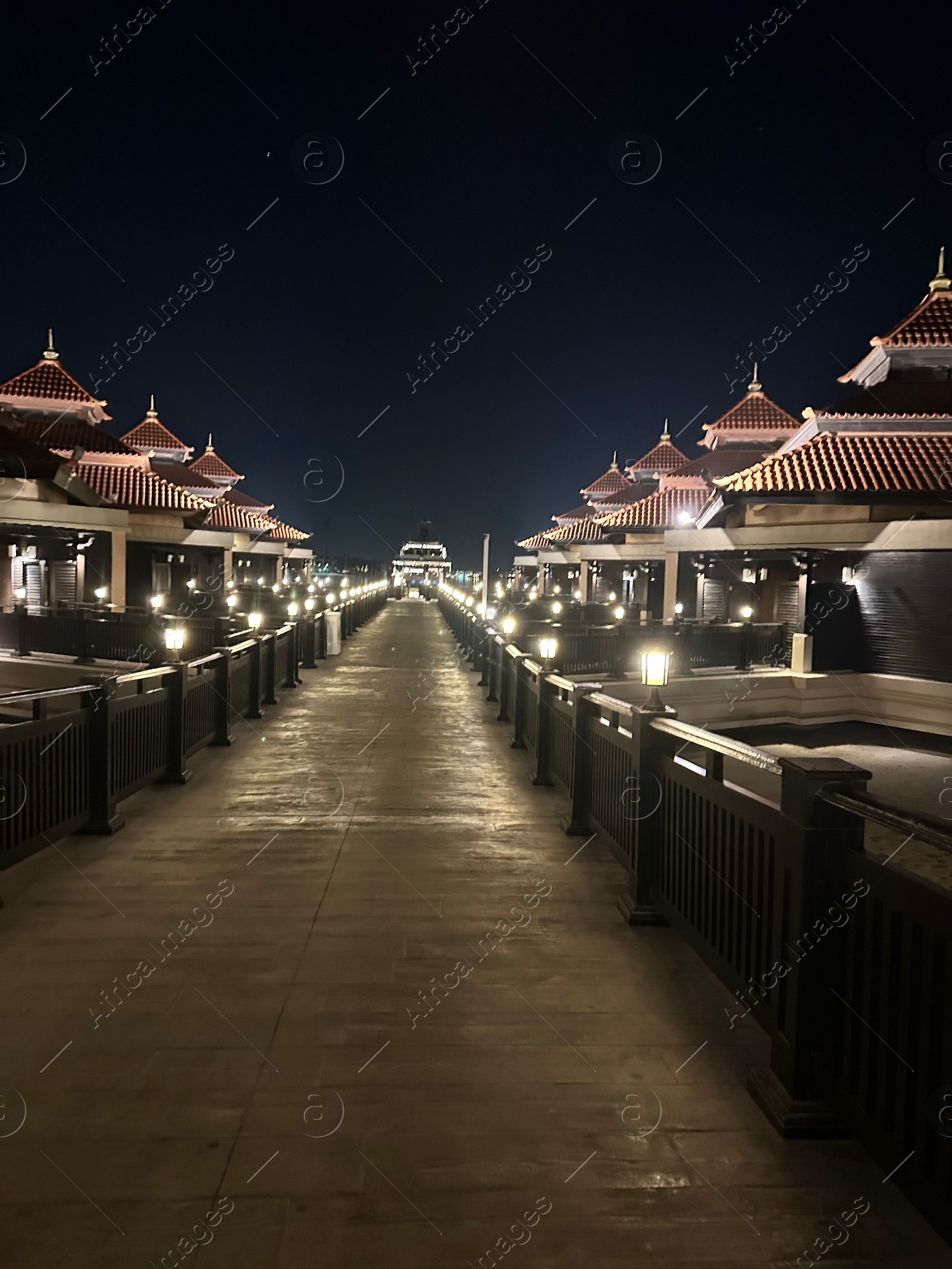 Photo of Paved pathway and buildings in city at night