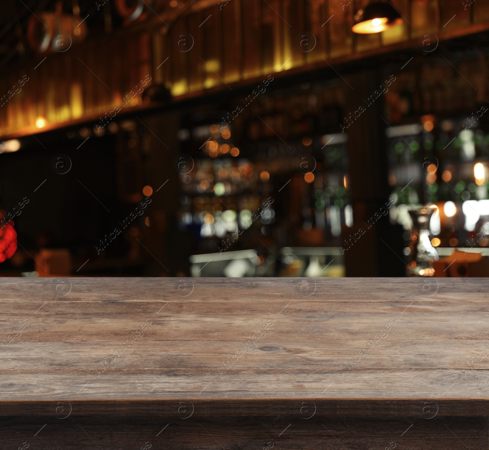 Image of Empty wooden surface and blurred view of bar interior. Space for design