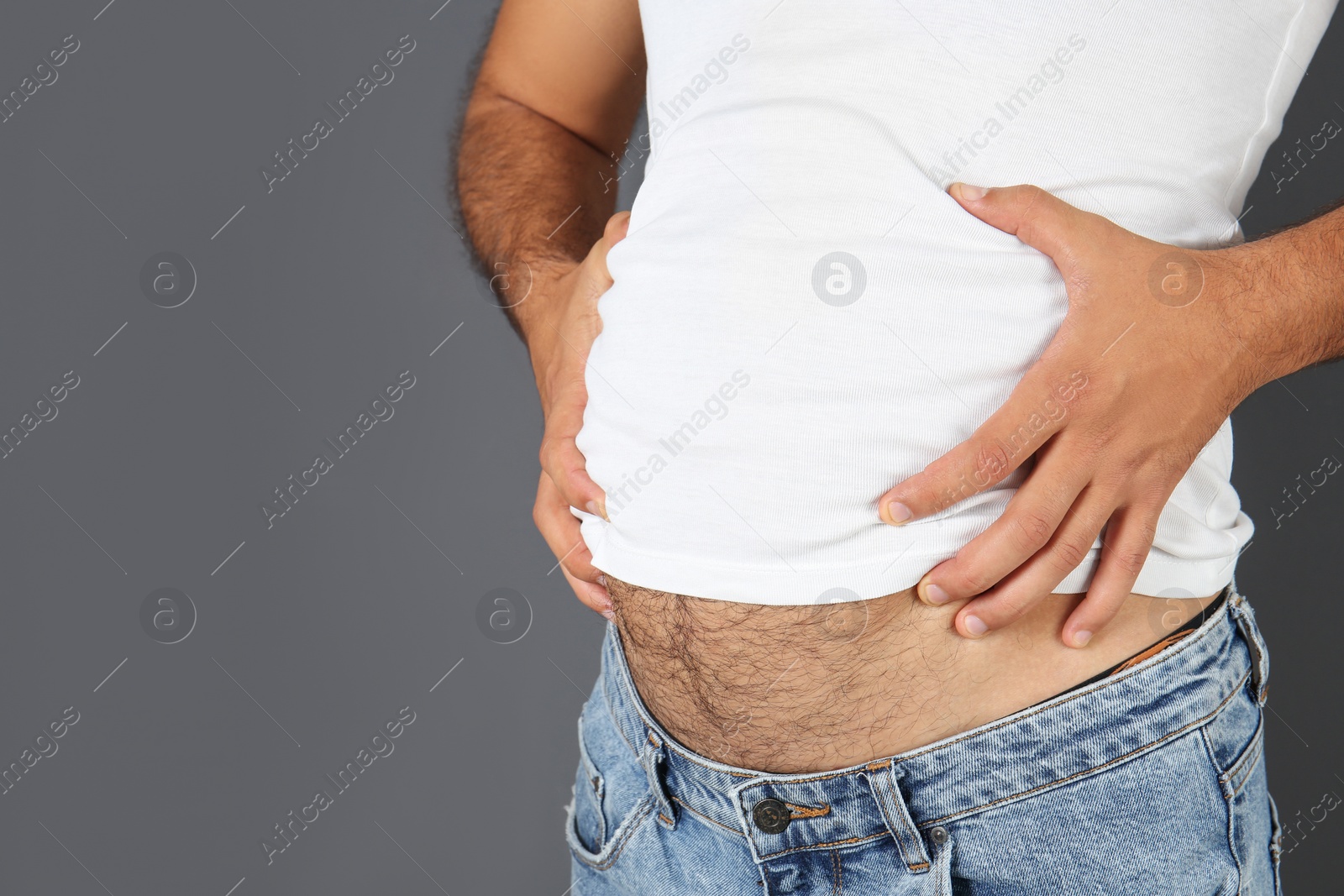 Photo of Overweight man on gray background, closeup view