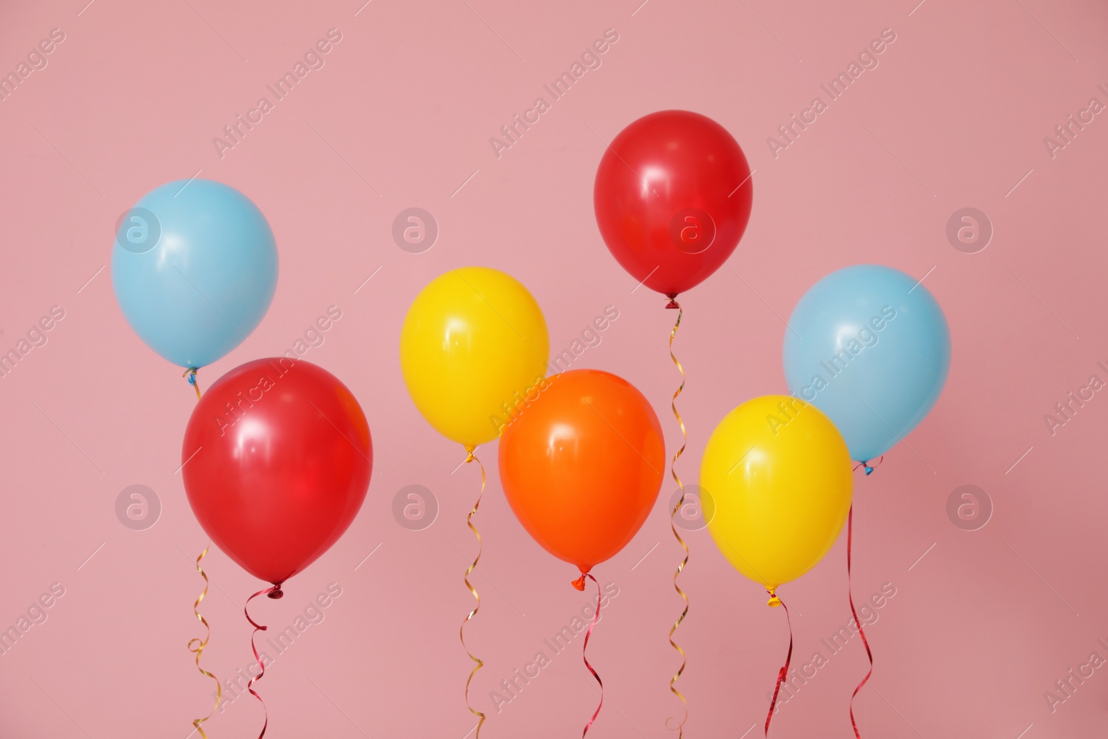 Photo of Bright balloons on color background. Celebration time