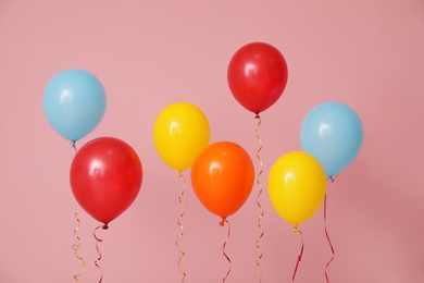 Photo of Bright balloons on color background. Celebration time