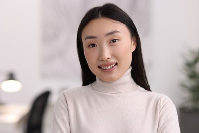 Portrait of smiling confident businesswoman in office