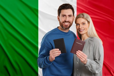 Image of Immigration. Happy couple with passports against national flag of Italy, space for text