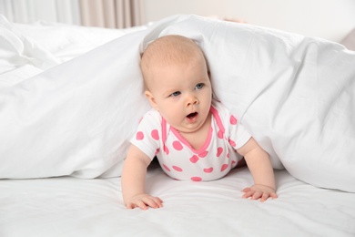 Photo of Cute baby girl in bed at home. Bedtime schedule