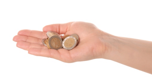 Woman holding coins in hand on white background, closeup