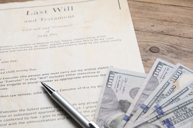 Photo of Last Will and Testament, dollar bills and pen on wooden table, closeup