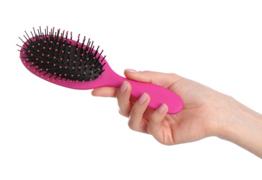 Photo of Woman holding hair brush against white background, closeup