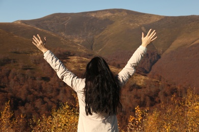 Photo of Woman in warm clothes enjoying mountain landscape