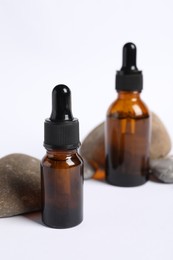 Photo of Composition with bottles of cosmetic serum on white background