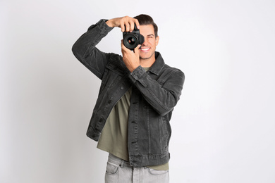 Professional photographer working on white background in studio