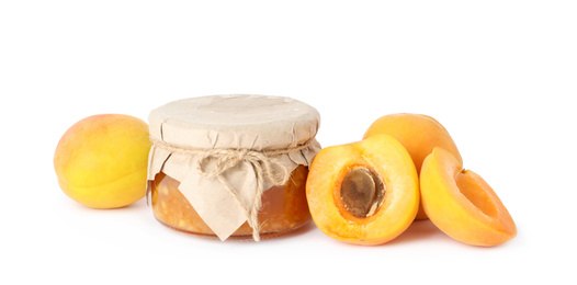 Photo of Jar of apricot jam and fresh fruits on white background