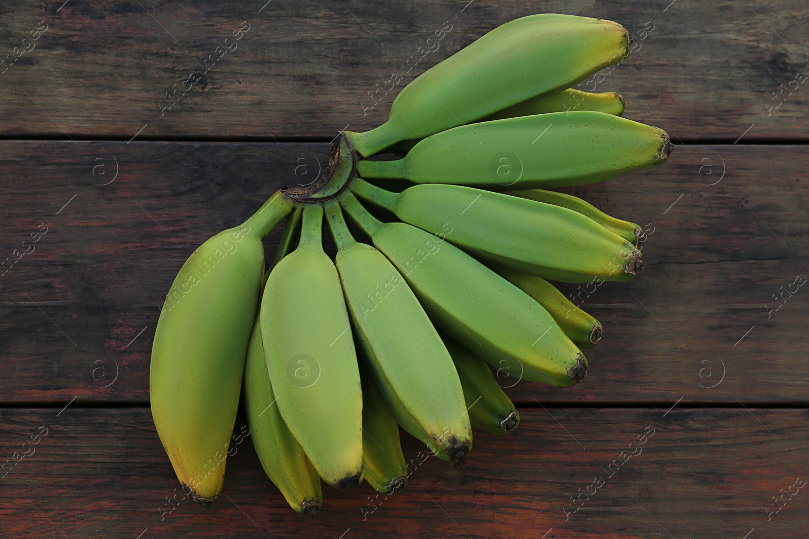 Photo of Bunch of delicious bananas on wooden table, top view