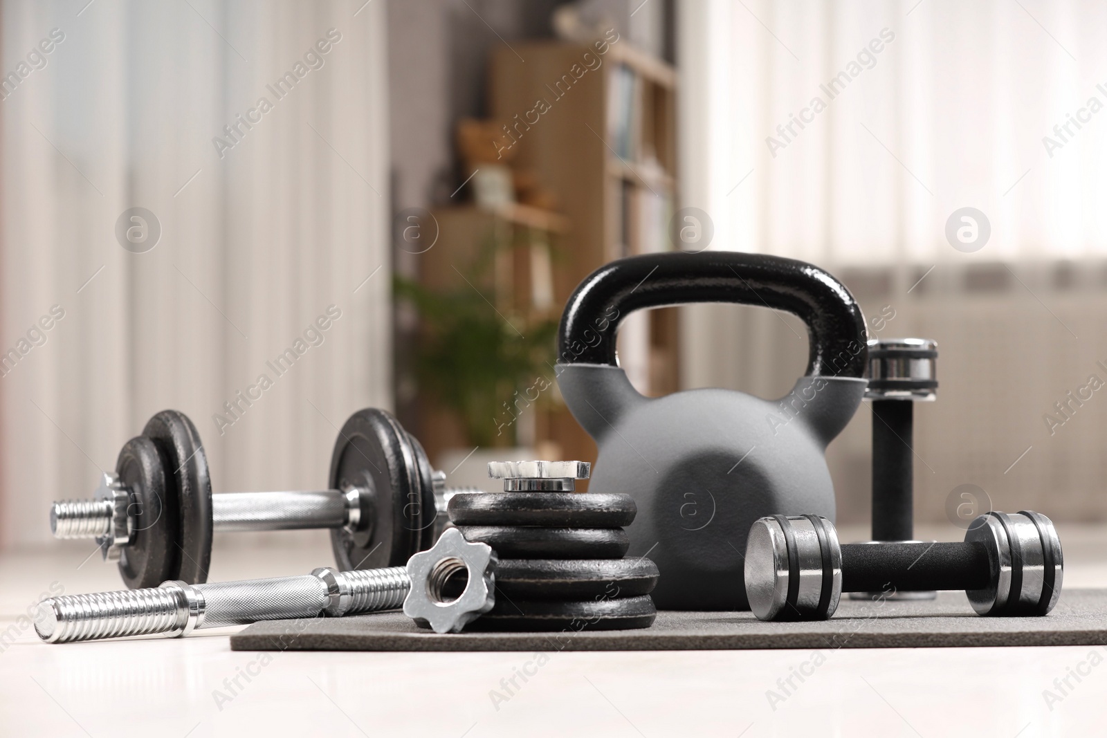 Photo of Many different sports equipment on floor indoors