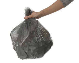 Woman holding trash bag filled with garbage on white background, closeup